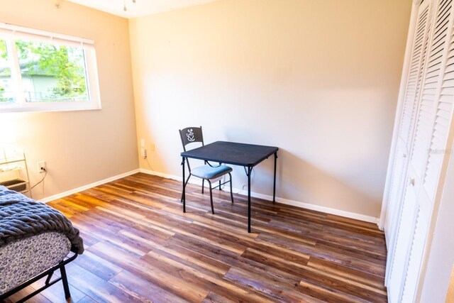 bedroom featuring wood finished floors and baseboards
