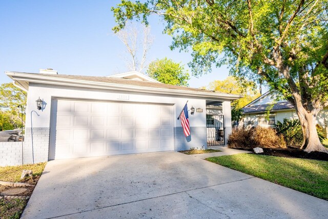 view of front of home with brick siding, an attached garage, and concrete driveway