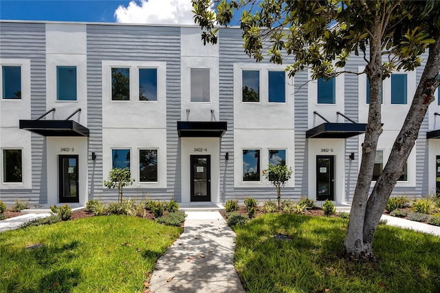 3402 E 28th Ave Unit 4, Tampa, FL 33605 - townhome / multi-family property featuring a front lawn and stucco siding