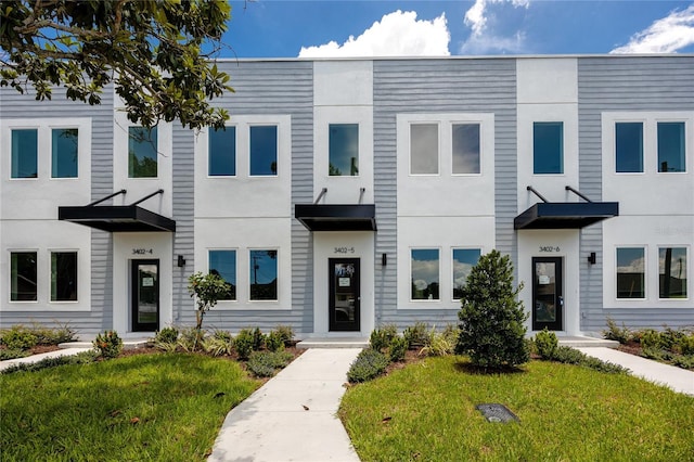 3402 E 28th Ave Unit 4, Tampa, FL 33605 - view of property with a front lawn and stucco siding