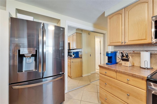 2533 Limewood Dr, Holiday, FL 34690 - kitchen featuring appliances with stainless steel finishes, light brown cabinets, decorative backsplash, and light tile patterned floors