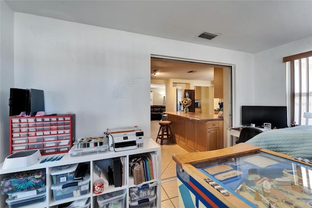 2533 Limewood Dr, Holiday, FL 34690 - bedroom with light tile patterned flooring and stainless steel fridge