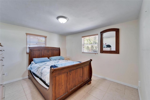 2533 Limewood Dr, Holiday, FL 34690 - bedroom with multiple windows and light tile patterned flooring