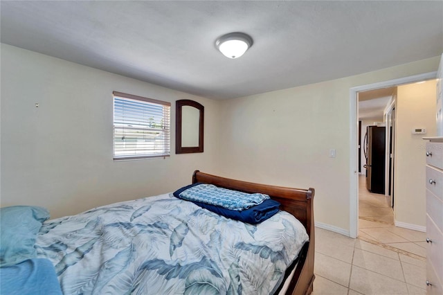 2533 Limewood Dr, Holiday, FL 34690 - bedroom with freestanding refrigerator and light tile patterned floors