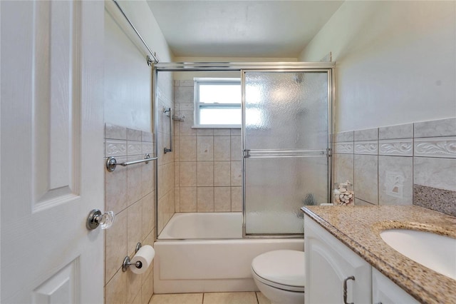 2533 Limewood Dr, Holiday, FL 34690 - bathroom with vanity, shower / bath combination with glass door, tile walls, and tile patterned flooring