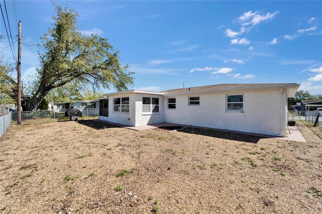 2533 Limewood Dr, Holiday, FL 34690 - rear view of house with a fenced backyard and stucco siding