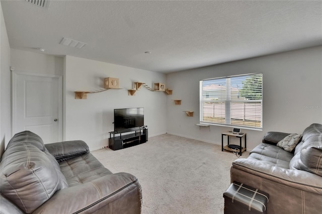 living room featuring visible vents, baseboards, carpet flooring, and a textured ceiling