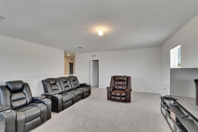 living area featuring visible vents and light colored carpet