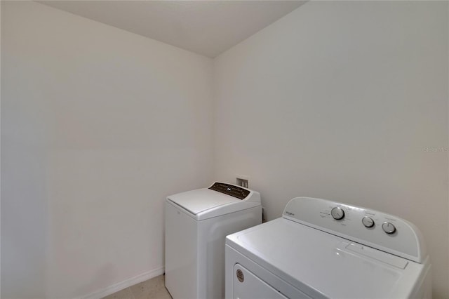 laundry room featuring baseboards, washer and dryer, and laundry area