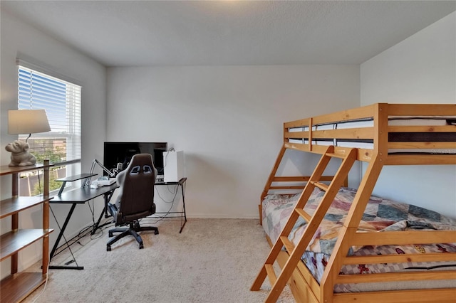 carpeted bedroom featuring baseboards