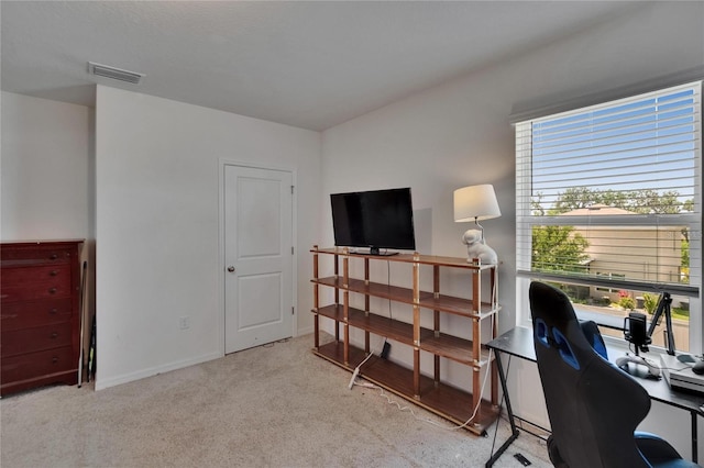 carpeted office with visible vents and baseboards