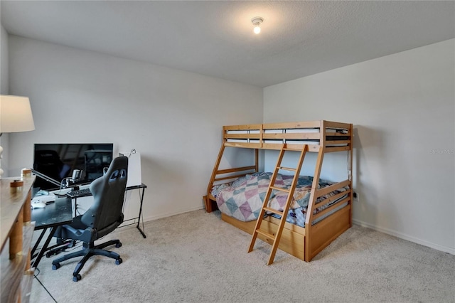 bedroom with baseboards and carpet