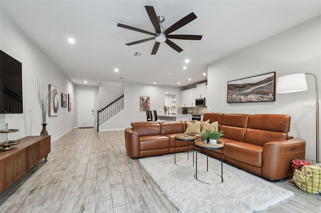 19398 Great Intention Way, Lutz, FL 33558 - living area featuring recessed lighting, light wood finished floors, visible vents, a ceiling fan, and stairs