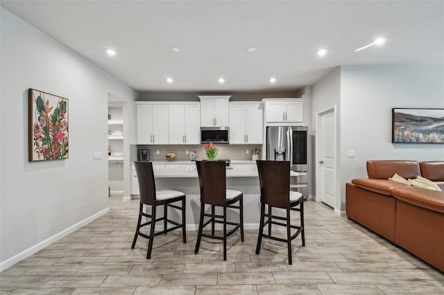 19398 Great Intention Way, Lutz, FL 33558 - kitchen with recessed lighting, stainless steel appliances, light countertops, decorative backsplash, and white cabinetry