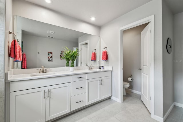 19398 Great Intention Way, Lutz, FL 33558 - bathroom with baseboards, a sink, double vanity, and toilet