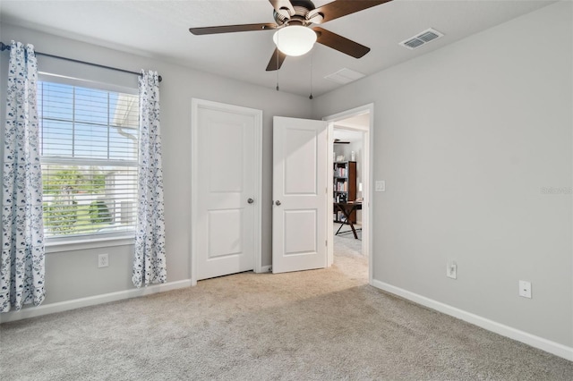 19398 Great Intention Way, Lutz, FL 33558 - unfurnished bedroom featuring visible vents, baseboards, a ceiling fan, and carpet flooring