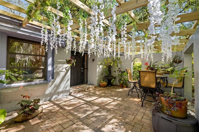view of patio featuring a pergola, fence, and outdoor dining space