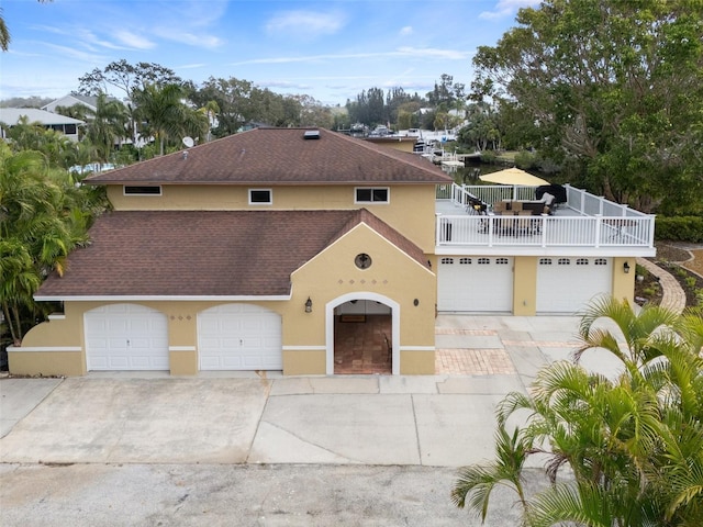378 Tennessee Ave, Crystal Beach, FL 34681 - view of front of house featuring stucco siding, driveway, and roof with shingles