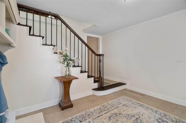 378 Tennessee Ave, Crystal Beach, FL 34681 - stairs with tile patterned flooring, crown molding, baseboards, and a textured ceiling