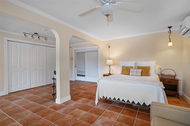 378 Tennessee Ave, Crystal Beach, FL 34681 - tiled bedroom featuring crown molding, an AC wall unit, baseboards, arched walkways, and ceiling fan
