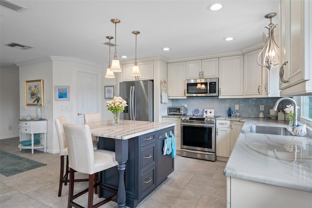 378 Tennessee Ave, Crystal Beach, FL 34681 - kitchen with visible vents, a sink, backsplash, and appliances with stainless steel finishes