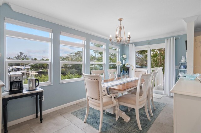 378 Tennessee Ave, Crystal Beach, FL 34681 - dining space featuring light tile patterned floors, crown molding, baseboards, and a chandelier