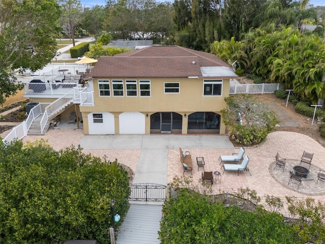 378 Tennessee Ave, Crystal Beach, FL 34681 - exterior space featuring a fire pit, stucco siding, fence, and a patio