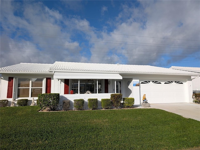 single story home featuring concrete driveway, stucco siding, a tiled roof, a front lawn, and a garage