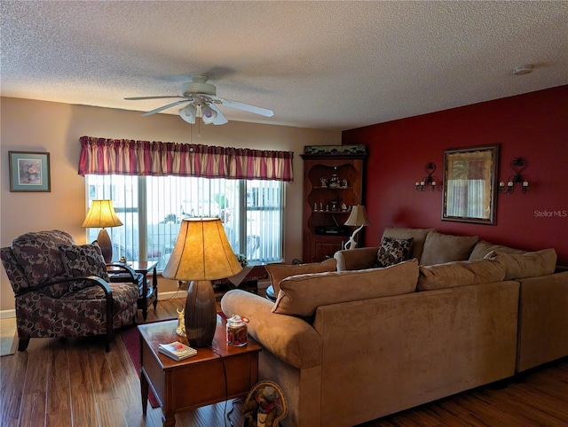 living room featuring a textured ceiling, ceiling fan, and wood finished floors