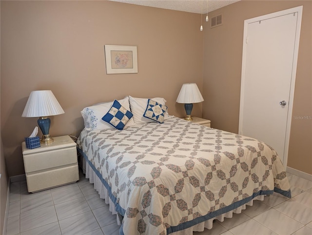 bedroom with light tile patterned flooring and visible vents