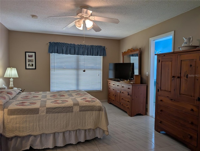 bedroom featuring a ceiling fan and a textured ceiling