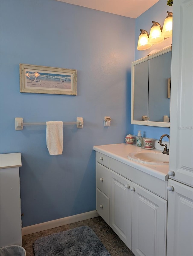 bathroom featuring baseboards, vanity, and tile patterned floors