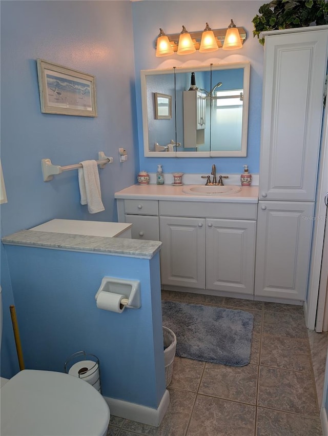 bathroom with tile patterned floors, toilet, and vanity