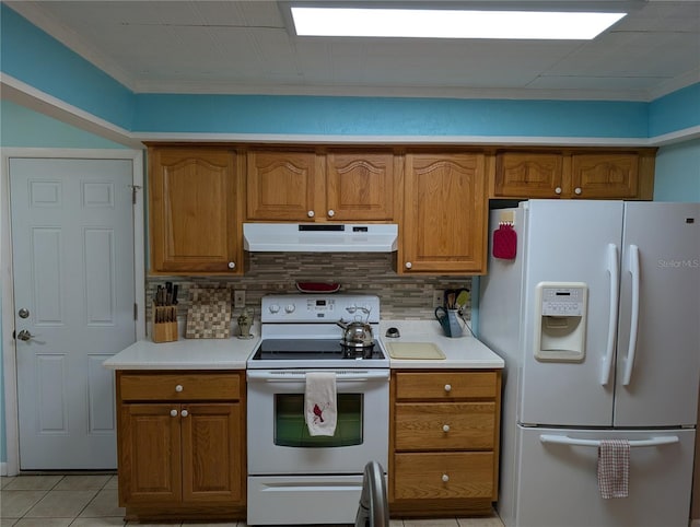 kitchen featuring light countertops, white appliances, under cabinet range hood, backsplash, and brown cabinets