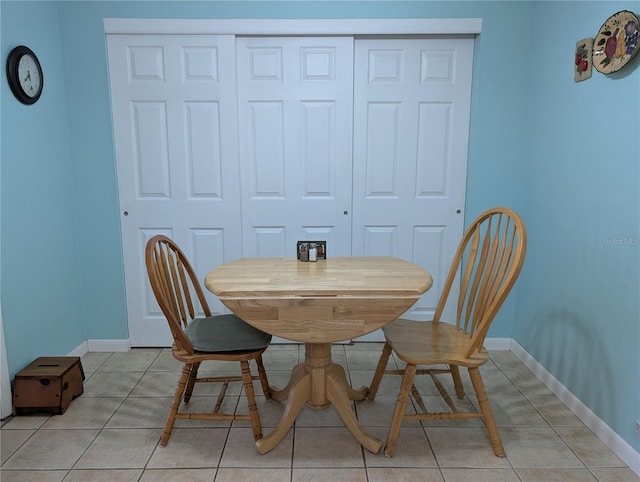 dining space with baseboards and light tile patterned floors