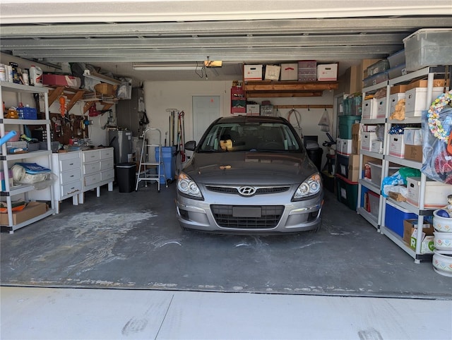 garage with a garage door opener and gas water heater