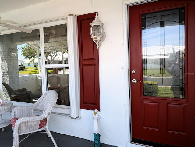 doorway to property featuring ceiling fan