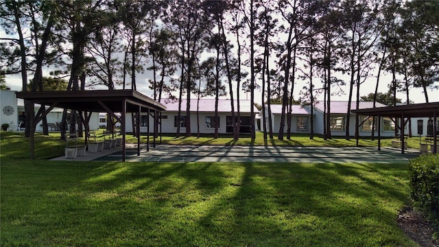 view of community with shuffleboard and a lawn
