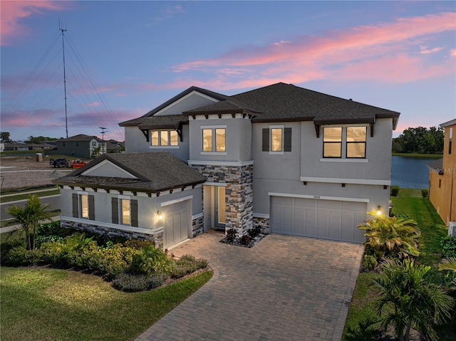 12808 Boggy Creek Dr, Riverview, FL 33579 - view of front facade with decorative driveway, stucco siding, stone siding, and a garage