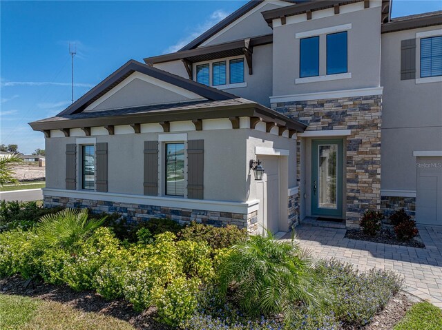12808 Boggy Creek Dr, Riverview, FL 33579 - view of front facade featuring stone siding and stucco siding