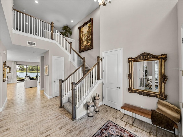 12808 Boggy Creek Dr, Riverview, FL 33579 - staircase with a towering ceiling, visible vents, and wood finished floors