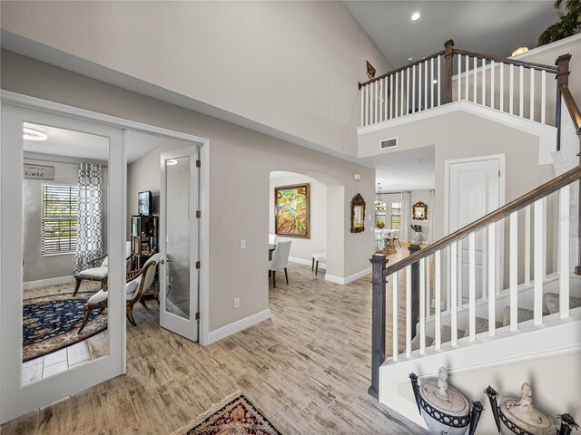 12808 Boggy Creek Dr, Riverview, FL 33579 - foyer with light wood-style floors, stairway, baseboards, visible vents, and arched walkways