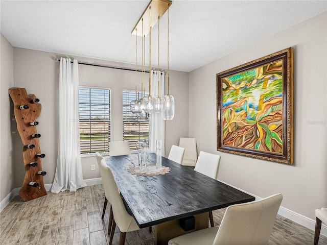 12808 Boggy Creek Dr, Riverview, FL 33579 - dining area featuring light wood finished floors, baseboards, and a chandelier