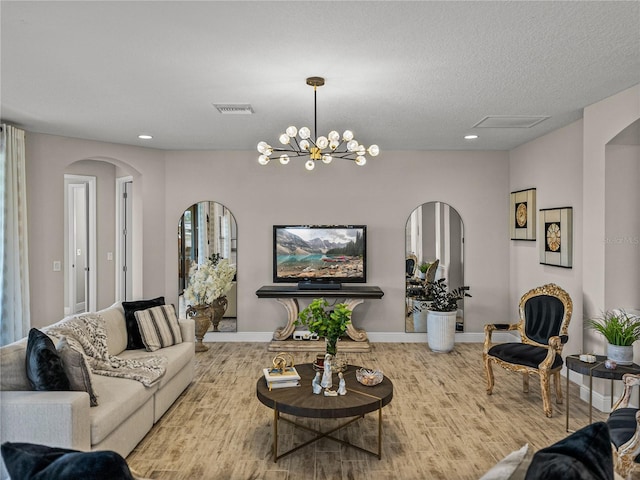 12808 Boggy Creek Dr, Riverview, FL 33579 - living area featuring visible vents, baseboards, recessed lighting, arched walkways, and an inviting chandelier