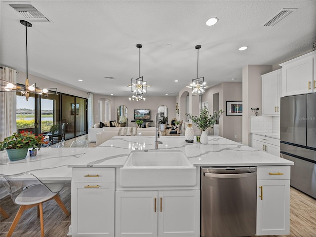 12808 Boggy Creek Dr, Riverview, FL 33579 - kitchen with a sink, visible vents, stainless steel appliances, and open floor plan