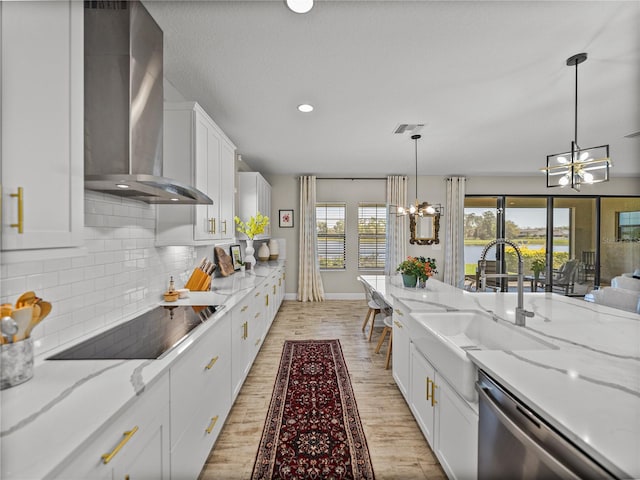 12808 Boggy Creek Dr, Riverview, FL 33579 - kitchen featuring wall chimney range hood, a notable chandelier, black electric cooktop, and stainless steel dishwasher