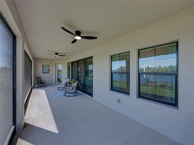 12808 Boggy Creek Dr, Riverview, FL 33579 - unfurnished sunroom with carpet floors, a textured wall, and a ceiling fan