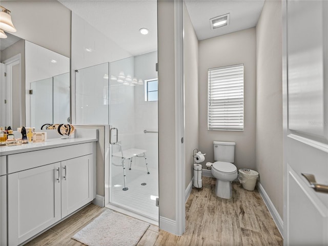 12808 Boggy Creek Dr, Riverview, FL 33579 - bathroom featuring vanity, toilet, baseboards, a stall shower, and wood finished floors