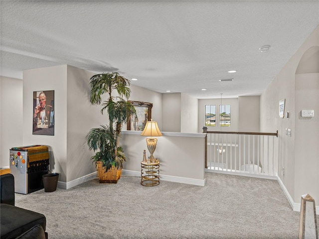 12808 Boggy Creek Dr, Riverview, FL 33579 - living area featuring baseboards, an upstairs landing, carpet, and a textured ceiling