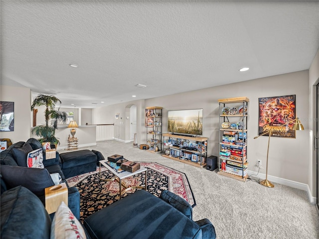 12808 Boggy Creek Dr, Riverview, FL 33579 - living area with arched walkways, carpet floors, a textured ceiling, and baseboards